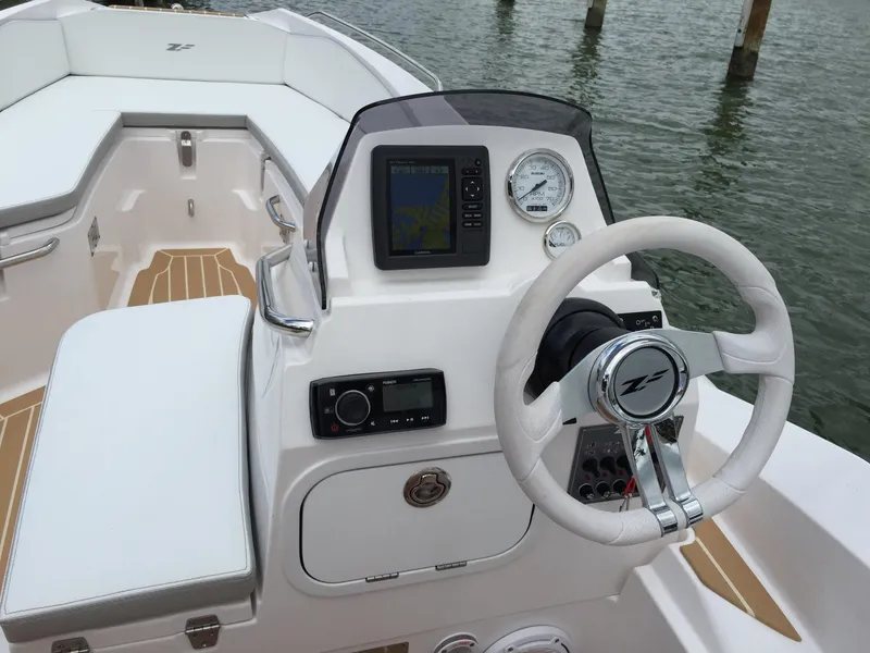 Slide: The Image of 2025 Zar Formenti ZF-5 boat cockpit with steering wheel and navigation system. - 14