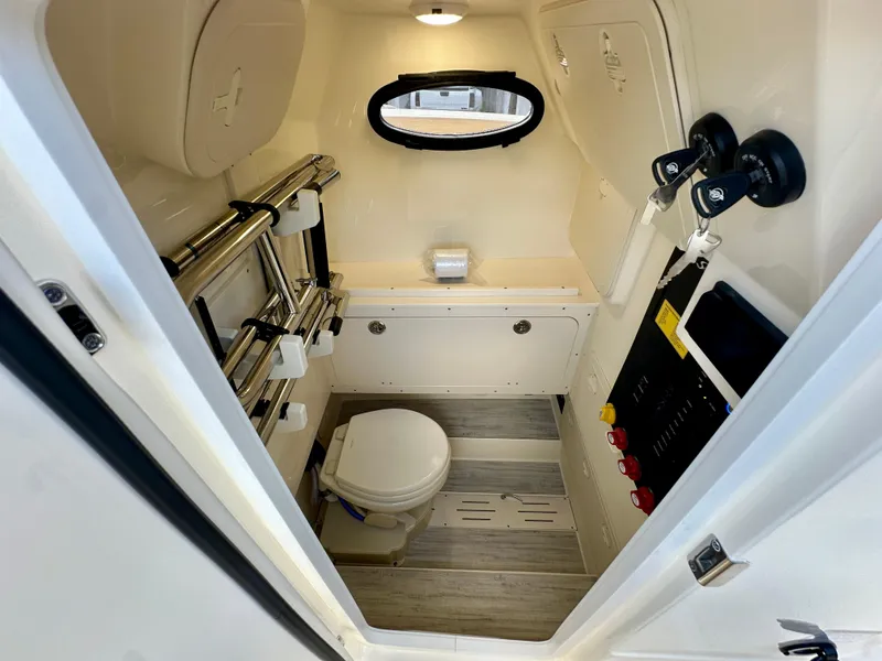 Slide: The Image of 2025 Scout 277 LXF boat interior with compact bathroom and modern fixtures. - 11