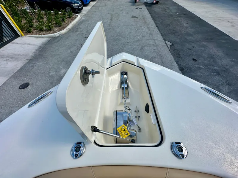 Slide: The Image of Open anchor compartment on 2025 Scout 277 LXF boat, showing anchor chain and mechanism. - 8