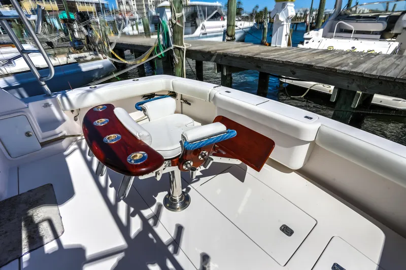 Slide: The Image of Bertram 450 Convertible 2005 yacht cockpit with fishing chair and marina view. - 11