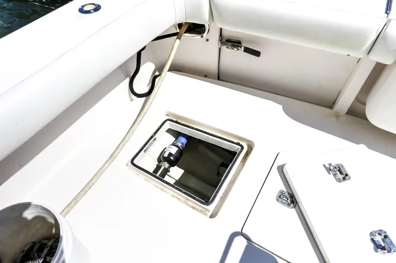 Slide: The Image of 2005 Bertram 450 Convertible boat deck with storage compartments and hose connection. - 14