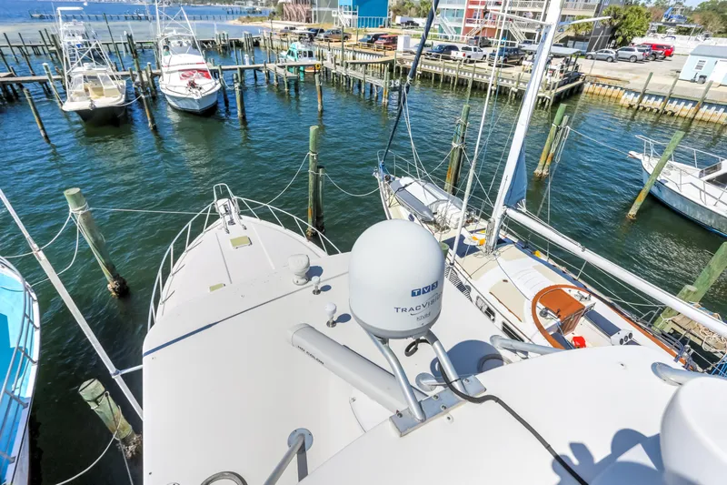 Slide: The Image of Bertram 450 Convertible 2005 yacht docked at marina with other boats. - 16