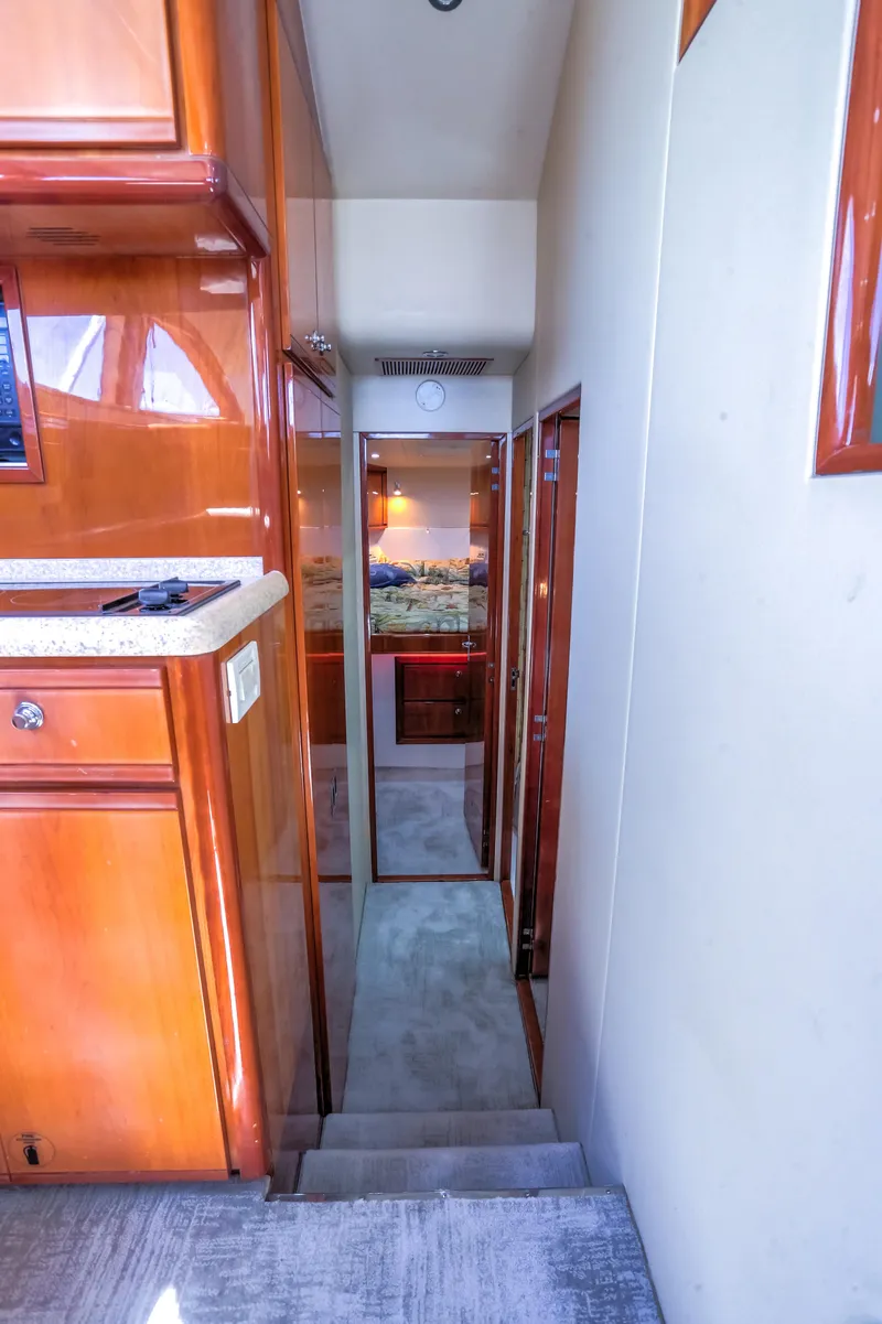 Slide: The Image of Interior hallway of a 2005 Bertram 450 Convertible yacht with wooden cabinetry. - 23