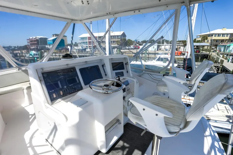 Slide: The Image of Bertram 450 Convertible 2005 yacht helm with dual seats and navigation controls. - 3