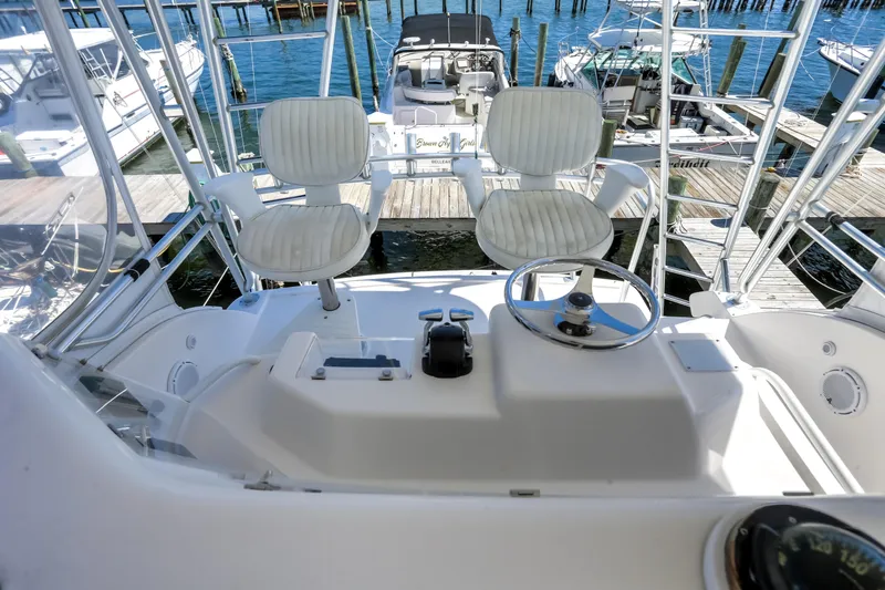 Slide: The Image of 2005 Bertram 450 Convertible yacht helm with dual seats and steering wheel. - 35