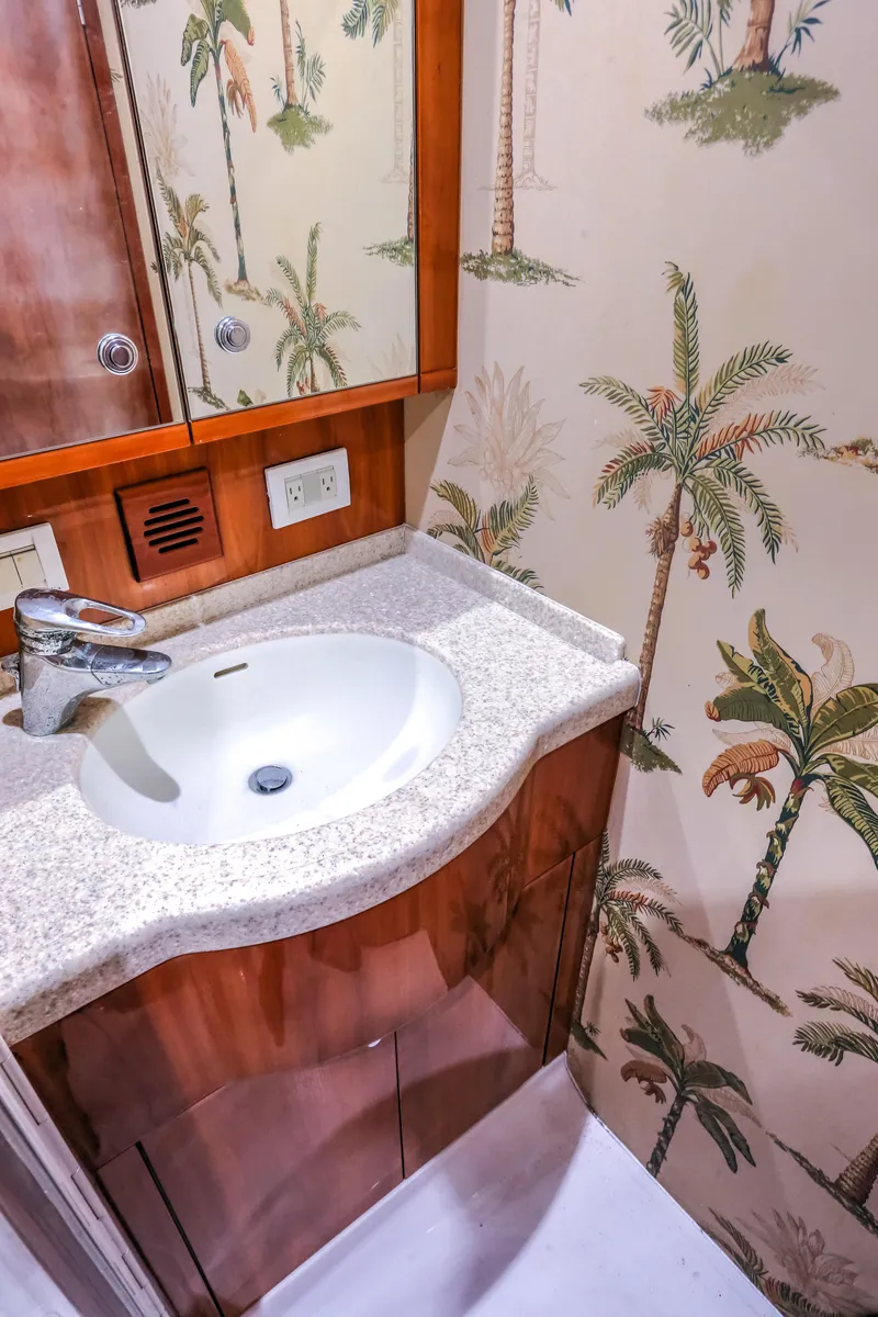 Slide: The Image of 2005 Bertram 450 Convertible bathroom with palm tree wallpaper and modern sink. - 38