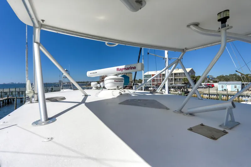 Slide: The Image of 2005 Bertram 450 Convertible yacht deck with Raymarine radar, docked at marina. - 40