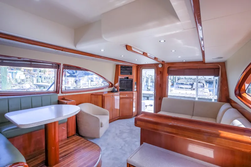 Slide: The Image of Luxurious interior of a 2005 Bertram 450 Convertible yacht with elegant wood finishes. - 43