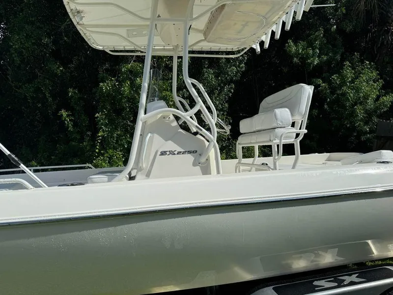 Slide: The Image of 2022 Skeeter SX2250 boat with seating and console, set against a lush green background. - 10