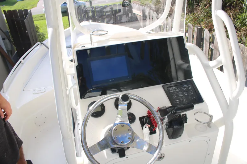 Slide: The Image of 2022 Skeeter SX2250 boat console with steering wheel and electronic controls. - 15