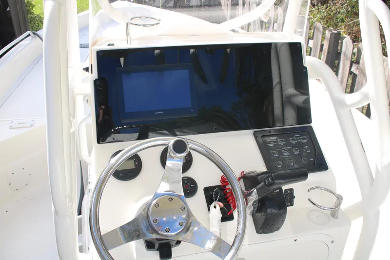 Slide: The Image of 2022 Skeeter SX2250 boat dashboard with steering wheel and electronic controls. - 16