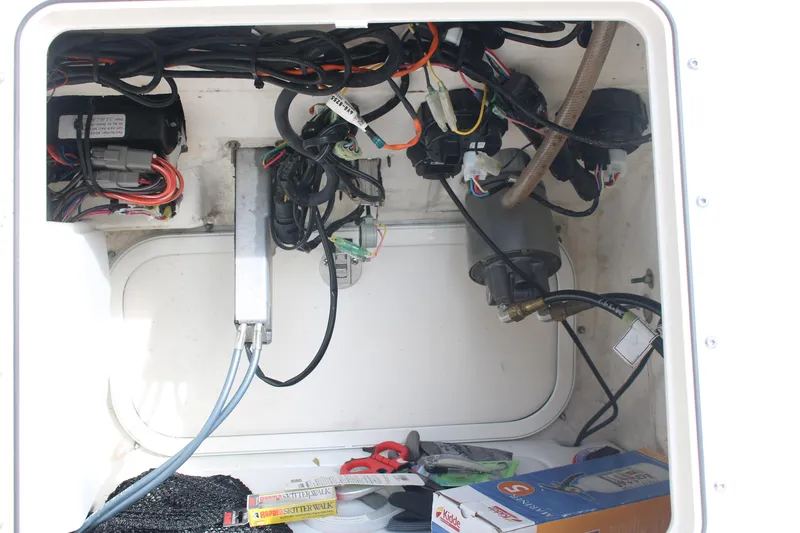 Slide: The Image of 2022 Skeeter SX2250 boat wiring compartment with cables and electrical components. - 24