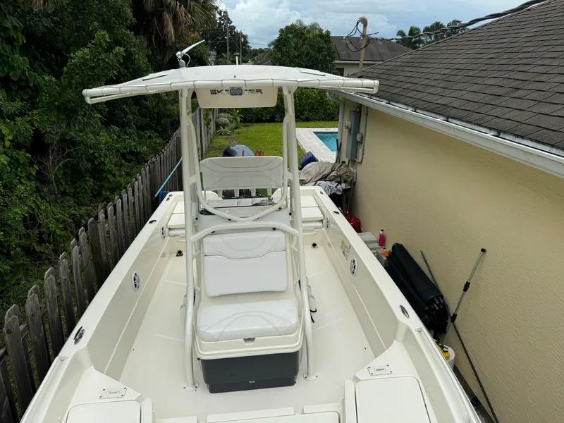 Slide: The Image of 2022 Skeeter SX2250 boat parked beside a house, featuring a center console and seating. - 4