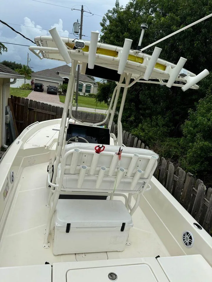 Slide: The Image of 2022 Skeeter SX2250 boat with rod holders and seating, parked outdoors. - 7