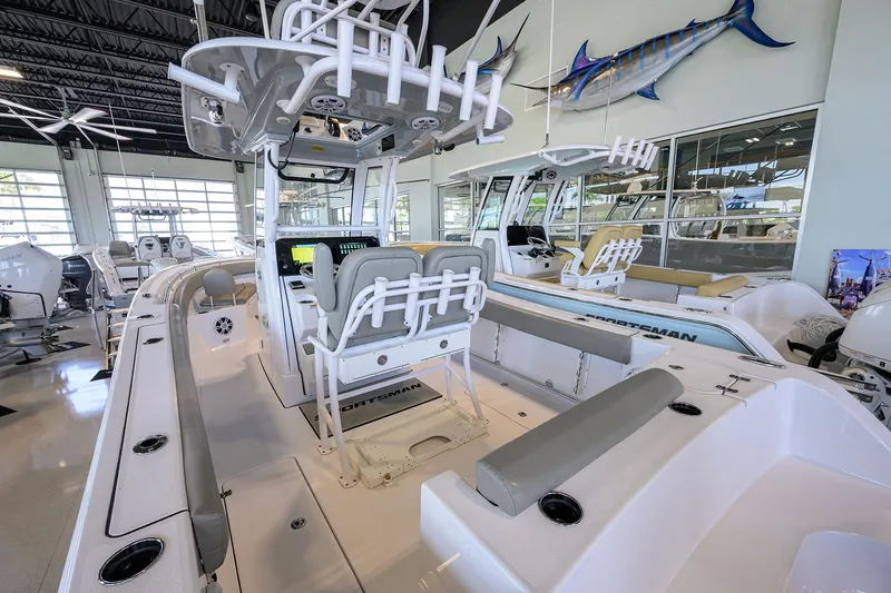 Slide: The Image of 2024 Sportsman Open 252 Center Console boat in showroom, featuring spacious seating and modern design. - 18