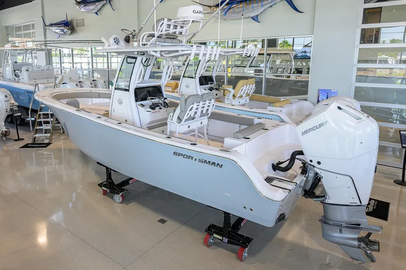Slide: The Image of 2024 Sportsman Open 252 Center Console boat displayed indoors with Mercury engine. - 2