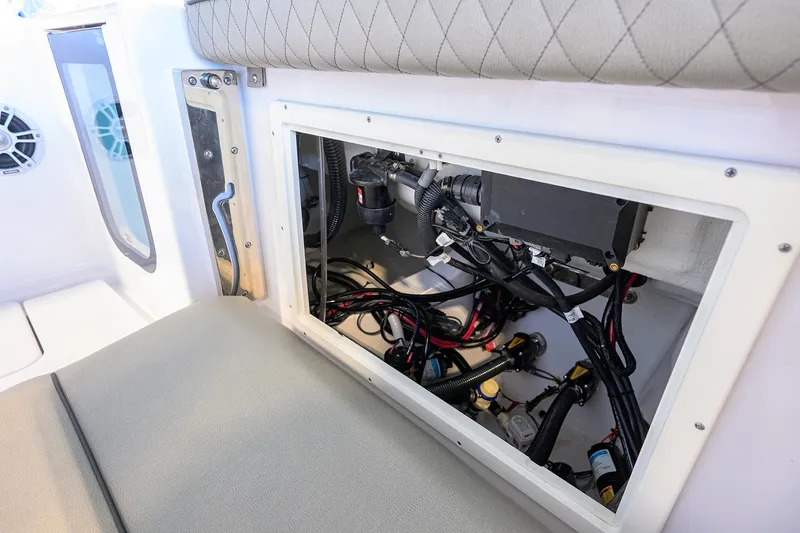 Slide: The Image of 2024 Sportsman Open 252 Center Console wiring compartment, showcasing organized cables and components. - 21