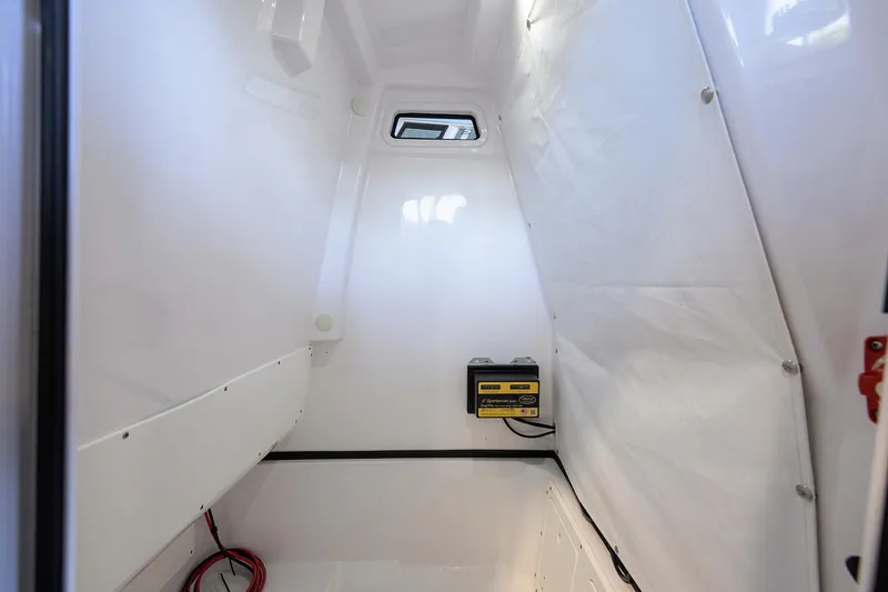 Slide: The Image of 2024 Sportsman Open 252 Center Console interior, featuring a compact, white storage compartment. - 22