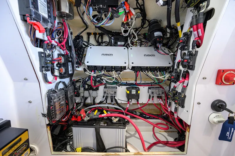 Slide: The Image of Electrical system inside a 2024 Sportsman Open 252 Center Console boat, showcasing wiring and components. - 23