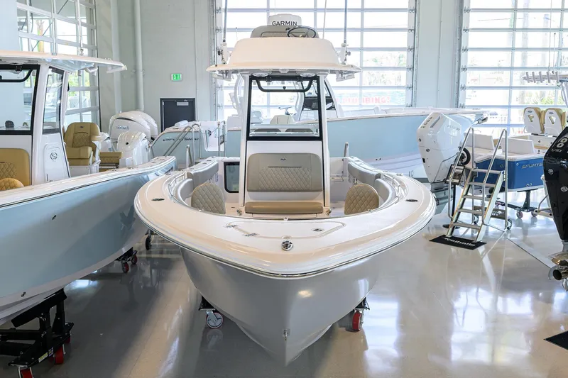 Slide: The Image of 2024 Sportsman Open 252 Center Console boat displayed in a showroom. - 3