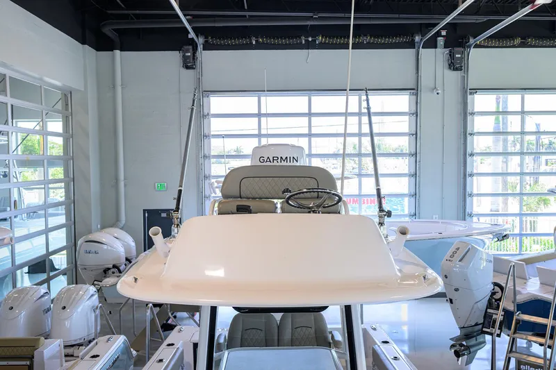 Slide: The Image of 2024 Sportsman Open 252 Center Console boat in showroom with Garmin equipment. - 4