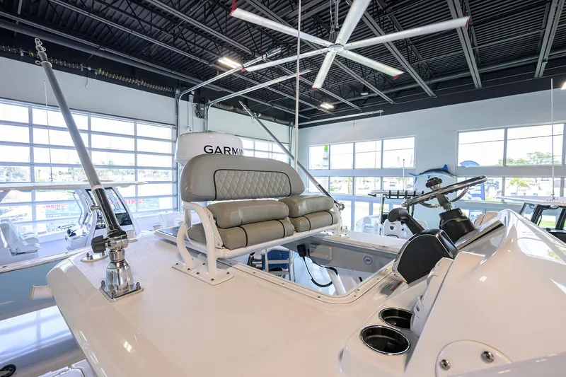 Slide: The Image of 2024 Sportsman Open 252 Center Console boat interior with seating and Garmin equipment. - 5