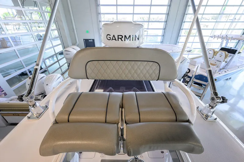 Slide: The Image of 2024 Sportsman Open 252 Center Console helm seating with Garmin electronics in a showroom. - 7