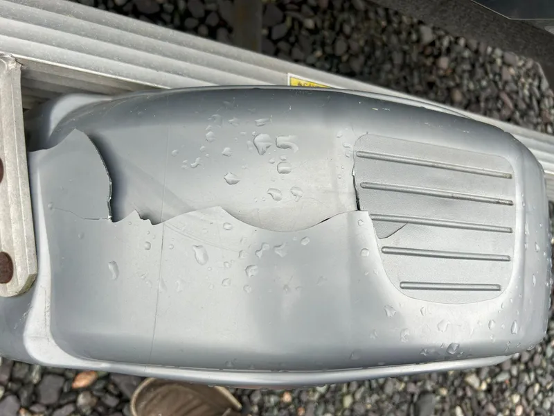 Slide: The Image of Cracked footrest on 2012 Sea-Doo GTX 155, wet with water droplets. - 13