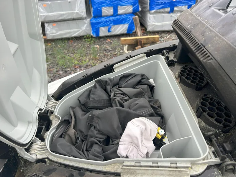 Slide: The Image of Open storage compartment of 2012 Sea-Doo GTX 155 with clothing inside. - 29