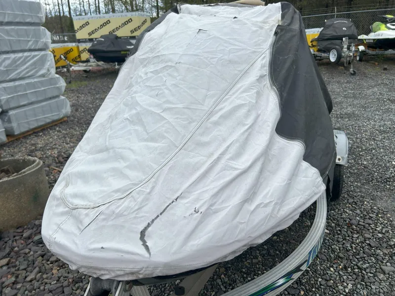Slide: The Image of Covered 2012 Sea-Doo GTX 155 jet ski on gravel lot. - 32