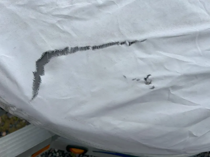 Slide: The Image of Torn cover on 2012 Sea-Doo GTX 155, showing significant wear and damage. - 33