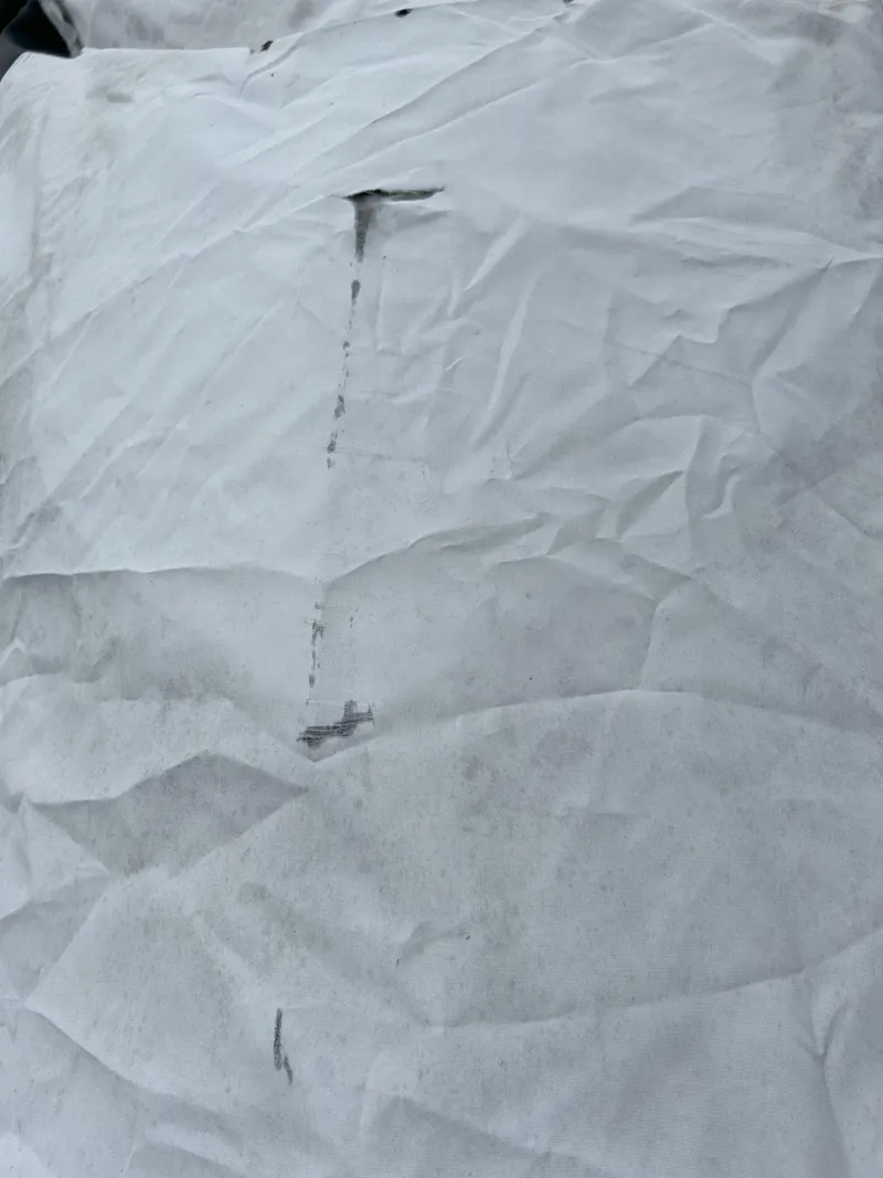 Slide: The Image of Crumpled white cover on 2012 Sea-Doo GTX 155, showing wear and tear. - 35