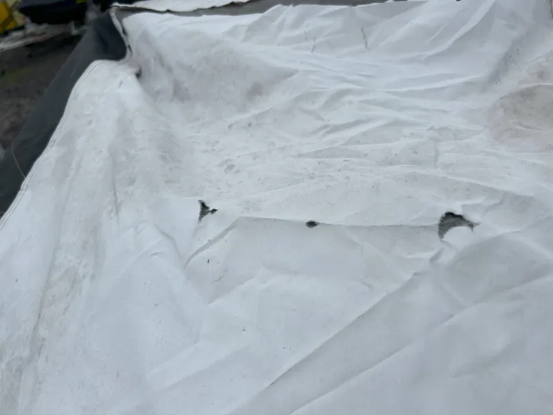 Slide: The Image of Torn cover on 2012 Sea-Doo GTX 155, showing wear and damage. - 36