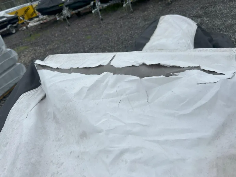 Slide: The Image of Torn cover on 2012 Sea-Doo GTX 155, revealing damage and wear. - 37