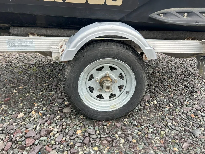 Slide: The Image of Trailer wheel for 2012 Sea-Doo GTX 155 on gravel surface. - 8