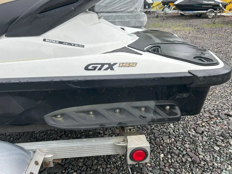 Slide: The Image of 2012 Sea-Doo GTX 155 jet ski on a trailer, parked on gravel. - 9