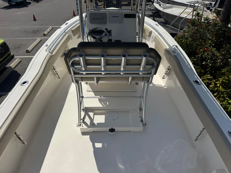 Slide: The Image of 2022 Key West 239 FS boat interior with seating and console, parked outdoors. - 13