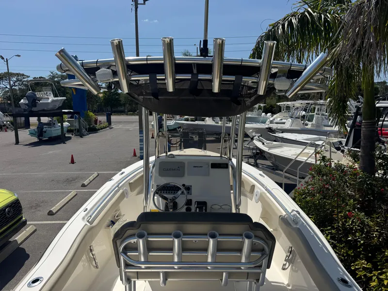 Slide: The Image of 2022 Key West 239 FS boat with T-top and rod holders in a marina setting. - 14