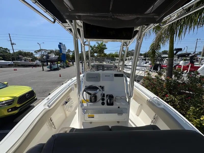 Slide: The Image of 2022 Key West 239 FS boat interior with steering console and seating. - 17