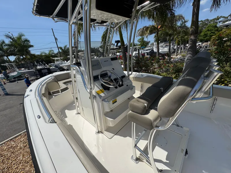 Slide: The Image of 2022 Key West 239 FS boat with console and seating, docked in a marina. - 18
