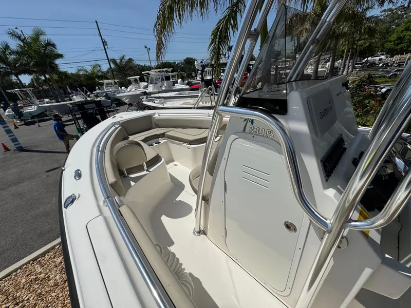 Slide: The Image of 2022 Key West 239 FS boat with sleek design, docked under palm trees. - 19