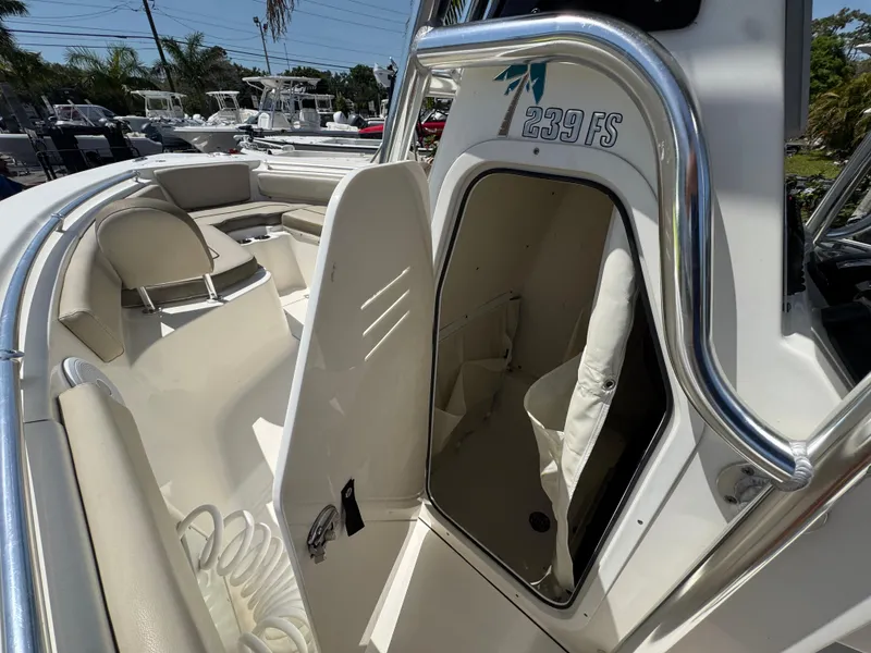 Slide: The Image of 2022 Key West 239 FS boat interior with open storage compartment and seating area. - 20