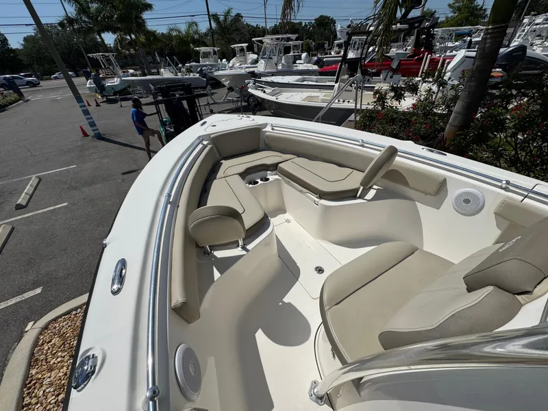 Slide: The Image of 2022 Key West 239 FS boat with spacious seating, parked outdoors in a marina. - 21