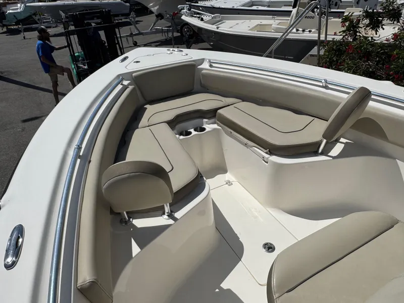 Slide: The Image of 2022 Key West 239 FS boat interior with cushioned seating and cup holders. - 22