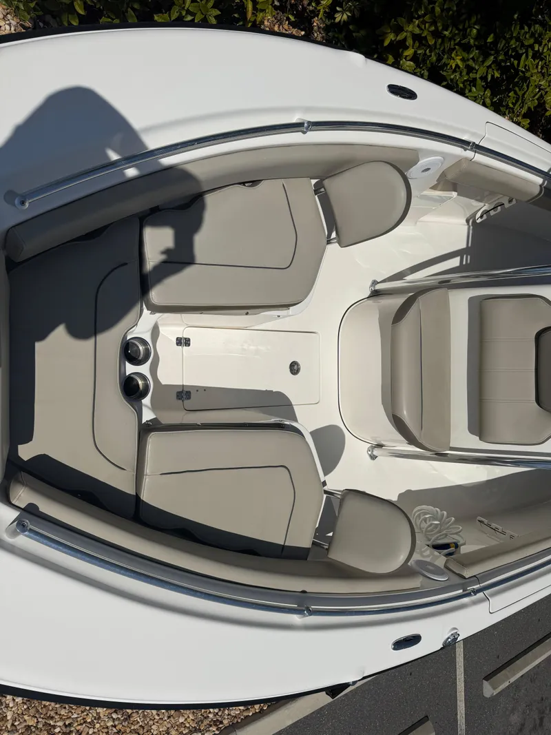 Slide: The Image of 2022 Key West 239 FS boat interior with cushioned seating and sleek design. - 23