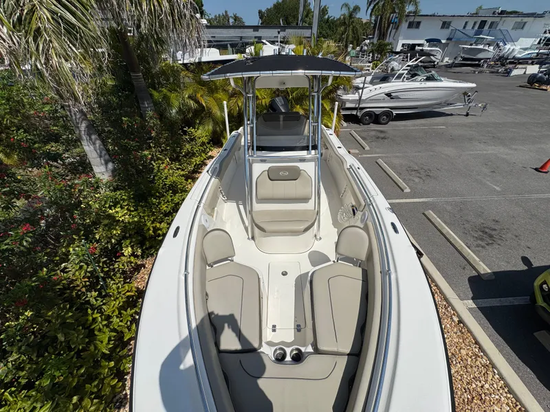 Slide: The Image of 2022 Key West 239 FS boat with seating, parked in a marina. - 25