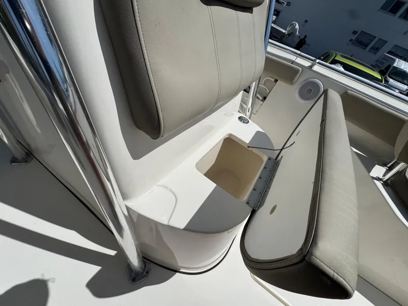 Slide: The Image of 2022 Key West 239 FS boat interior with storage compartment and cushioned seating. - 26