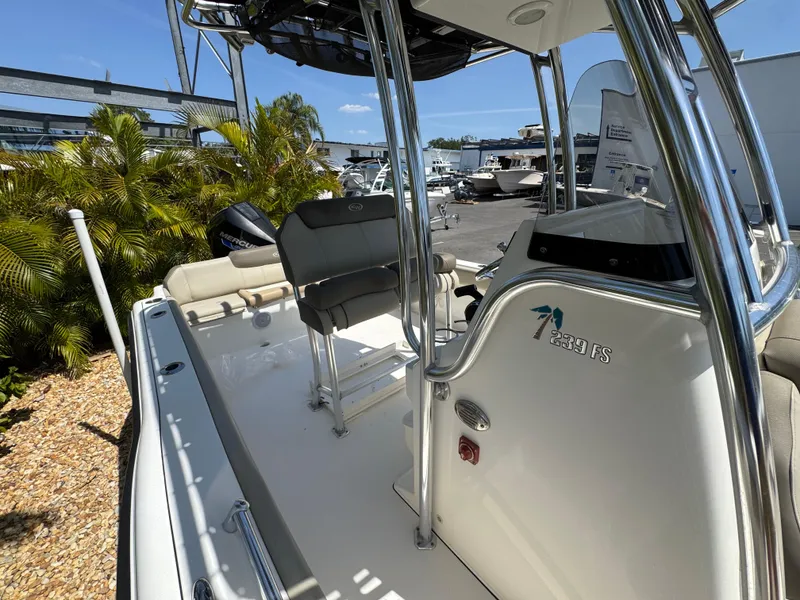 Slide: The Image of 2022 Key West 239 FS boat, featuring sleek design and modern seating, docked outdoors. - 27