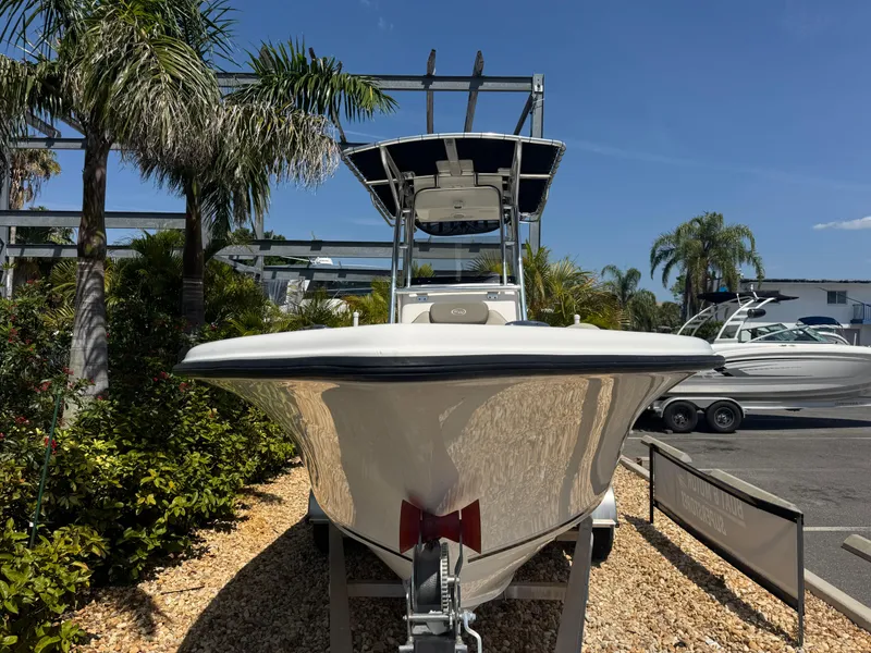 Slide: The Image of 2022 Key West 239 FS boat displayed outdoors with palm trees and clear sky. - 3