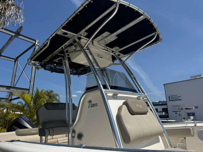 Slide: The Image of 2022 Key West 239 FS boat with T-top and seating, under clear blue sky. - 5